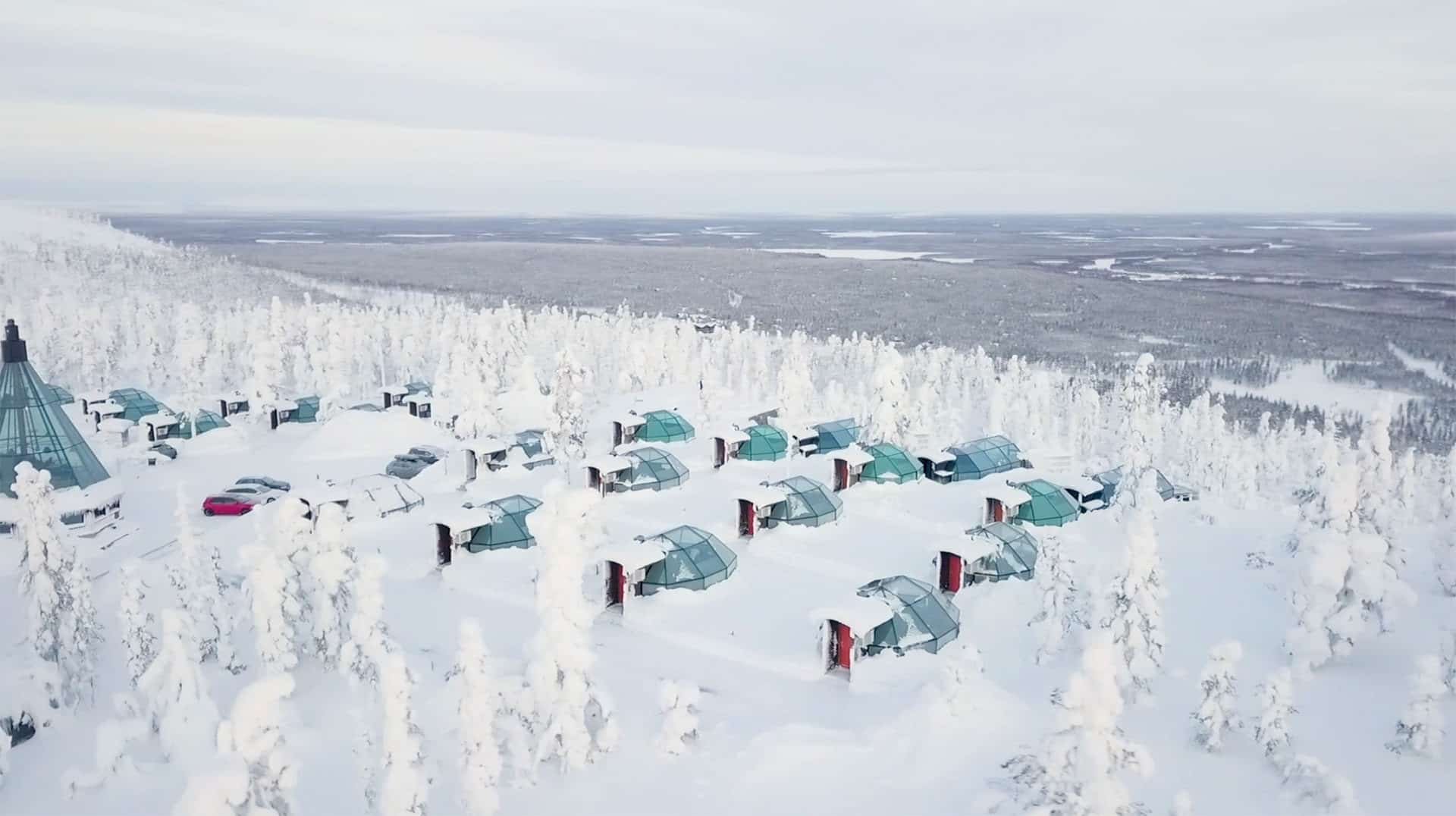 Levin Iglut’s glass igloos on a snowy fell slope, from the air