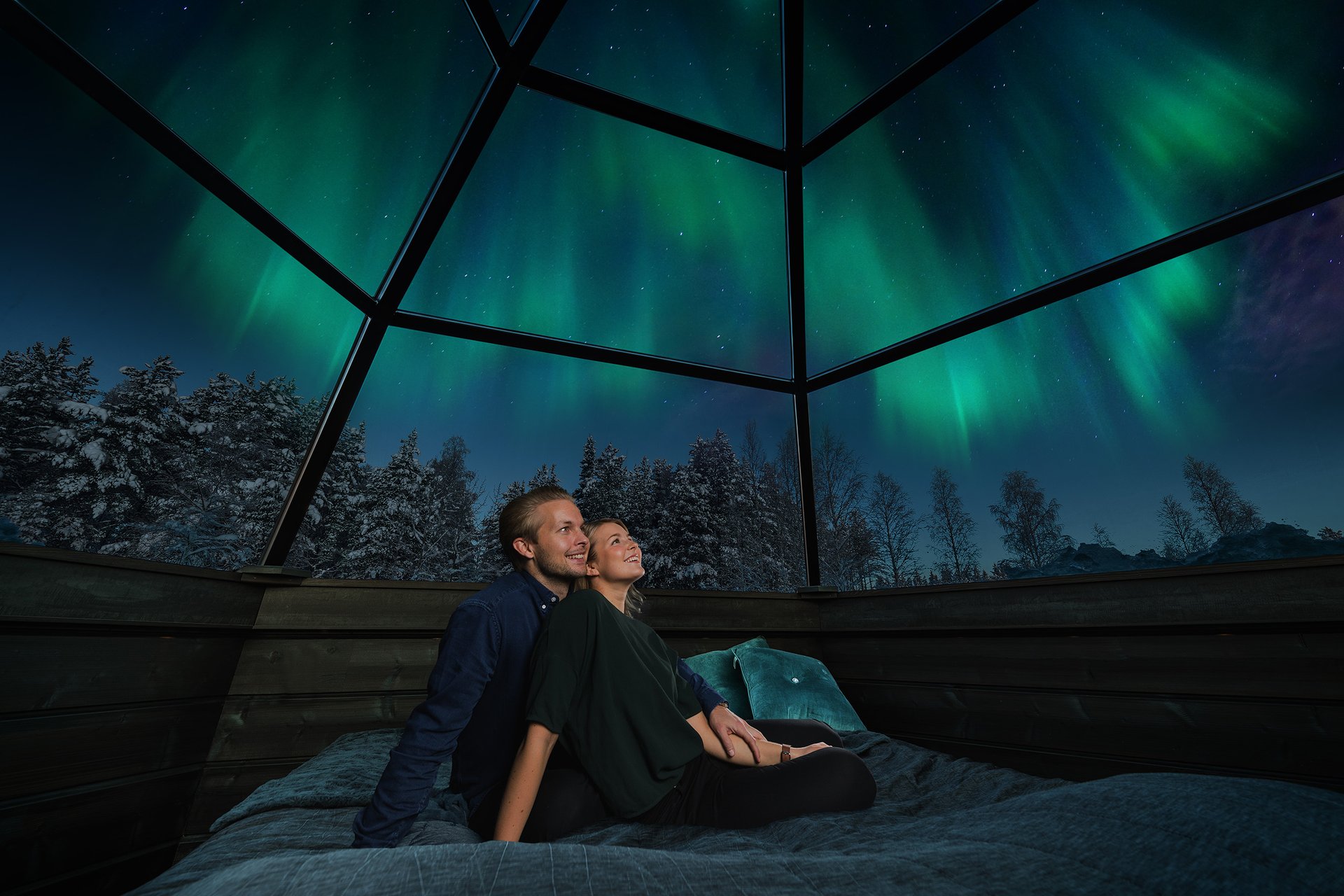 Watching the northern lights from a glass igloo at the Arctic SnowHotel