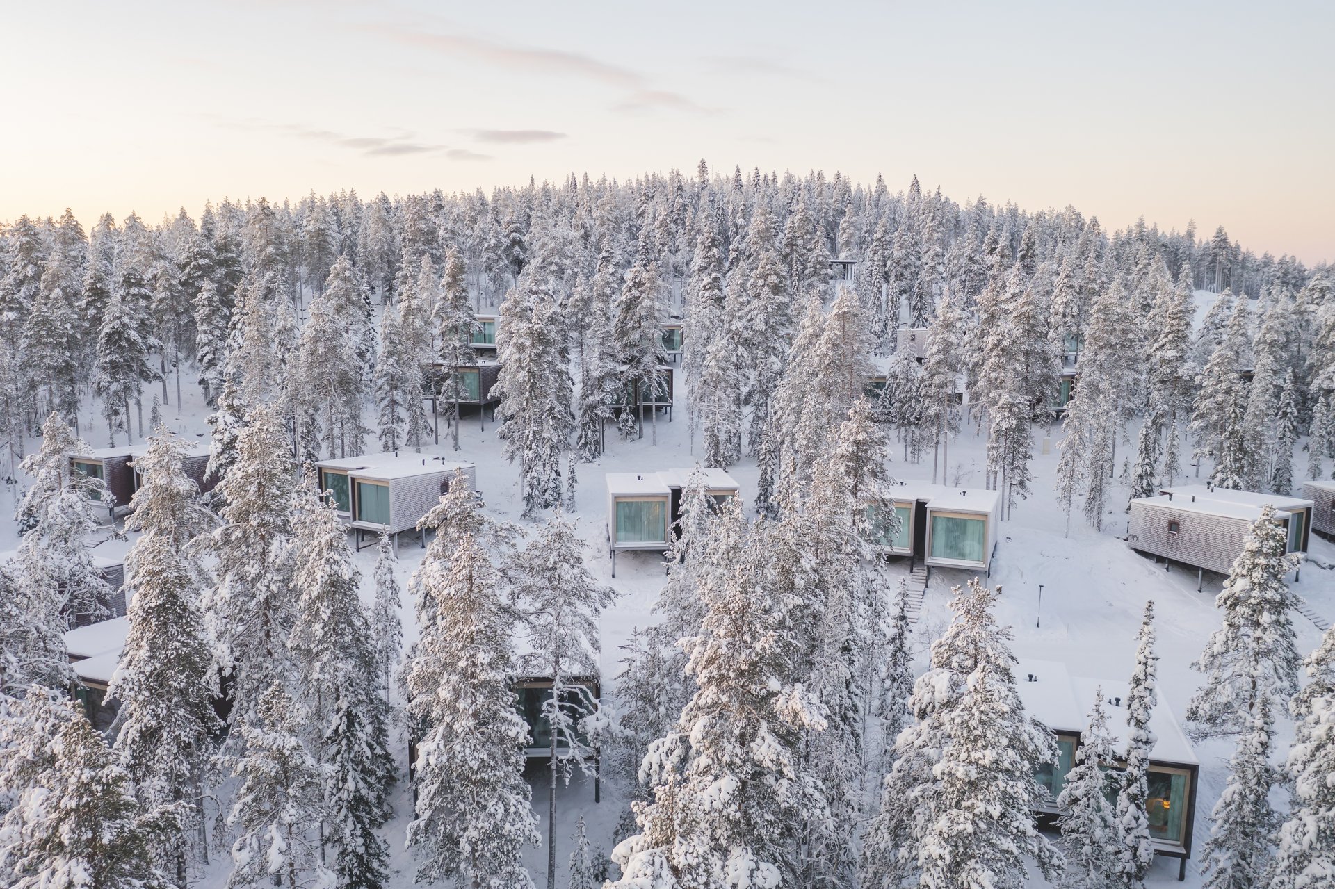 The Arctic TreeHouse Hotel’s suites in the snow-laden forest from the air